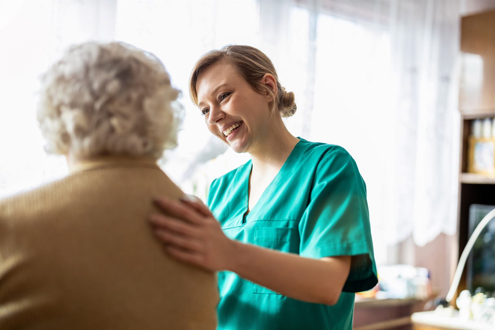 A Labs On Call phlebotomist comforting a patient during a home visit
